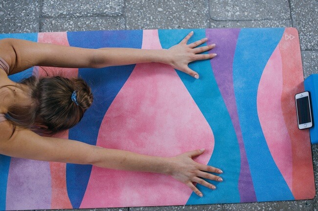 A person stretching on a yoga mat